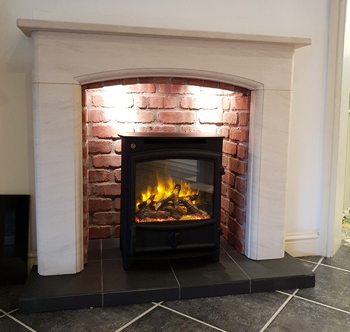 Sissari limestone fireplace with brick effect chamber